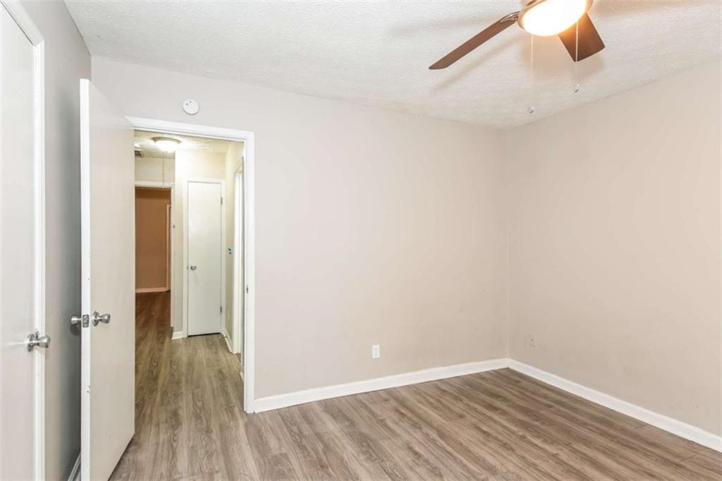 2356 Wingfoot Place Decatur, GA 30035 - Photo 14 of 20 a view of a room with wooden floor closet and windows