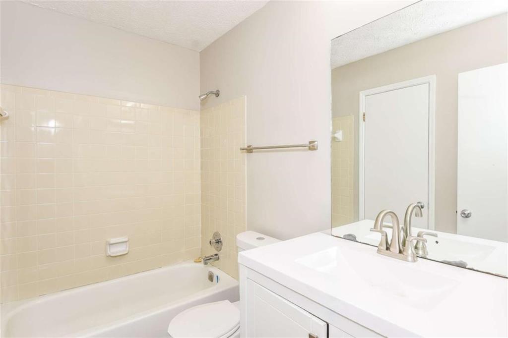 2356 Wingfoot Place Decatur, GA 30035 - Photo 16 of 20 a bathroom with a granite countertop sink a toilet and shower