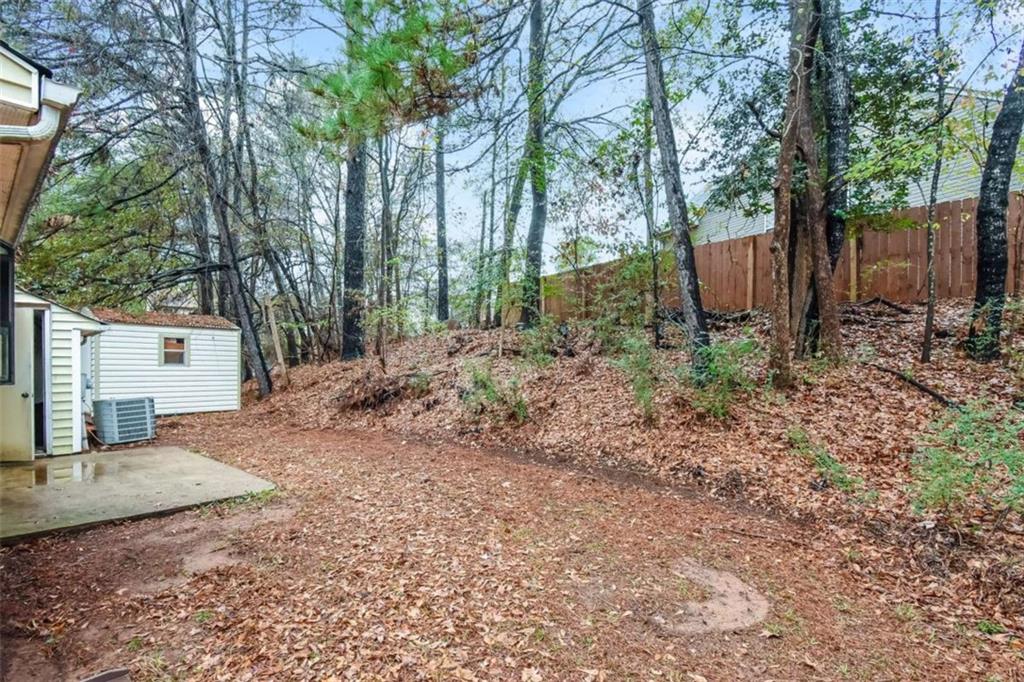 2356 Wingfoot Place Decatur, GA 30035 - Photo 20 of 20 a view of a backyard with large trees and wooden fence