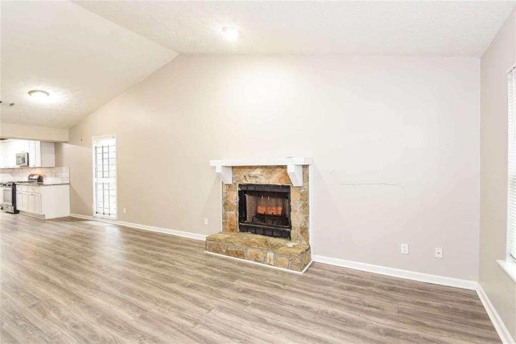 2356 Wingfoot Place Decatur, GA 30035 - Photo 4 of 20 a view of a livingroom with wooden floor and a fireplace