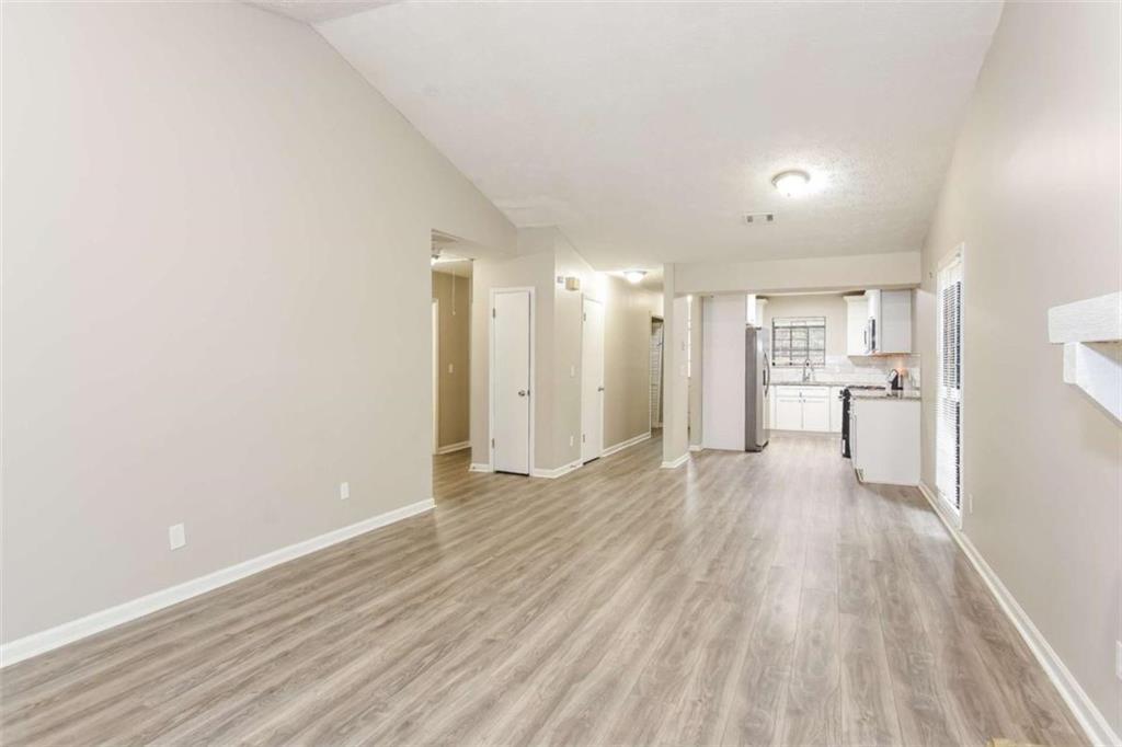 2356 Wingfoot Place Decatur, GA 30035 - Photo 6 of 20 a view of a big room with wooden floor and a window