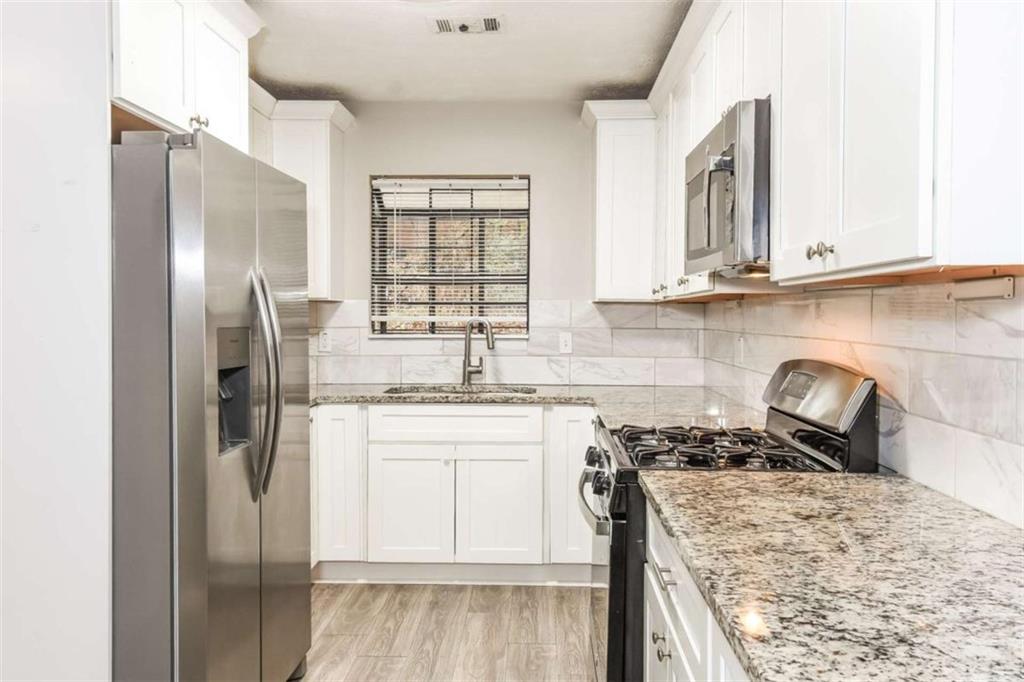 2356 Wingfoot Place Decatur, GA 30035 - Photo 8 of 20 a kitchen with stainless steel appliances granite countertop a refrigerator a stove and a sink