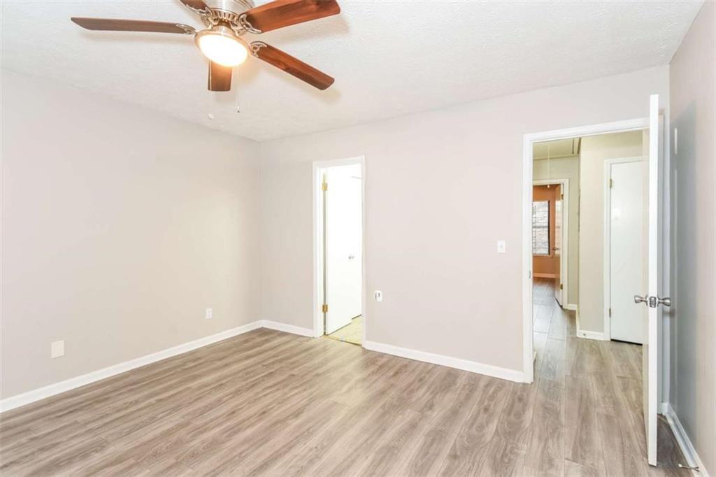 2356 Wingfoot Place Decatur, GA 30035 - Photo 9 of 20 an empty room with wooden floor fan and windows