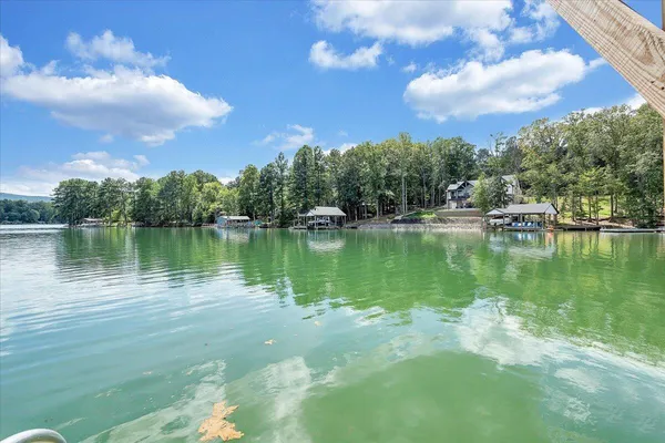 a view of a lake with houses in the back