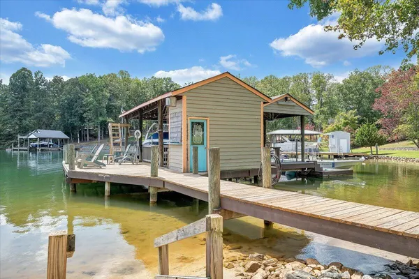 a view of a house with swimming pool and sitting area
