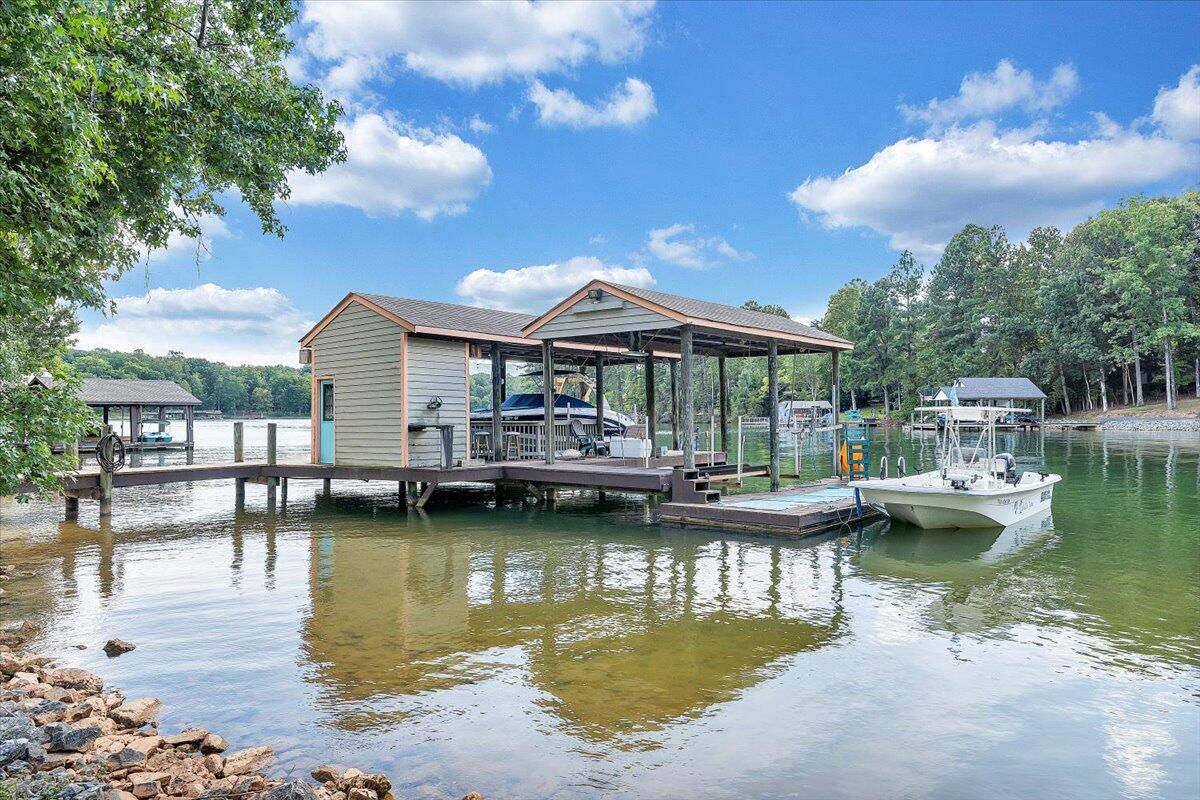 2544 Patmos Church Road Huddleston, VA 24104 - Photo 32 of 33 a view of a lake with a table and chairs under an umbrella