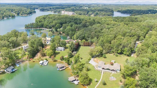 an aerial view of residential house with outdoor space and lake view