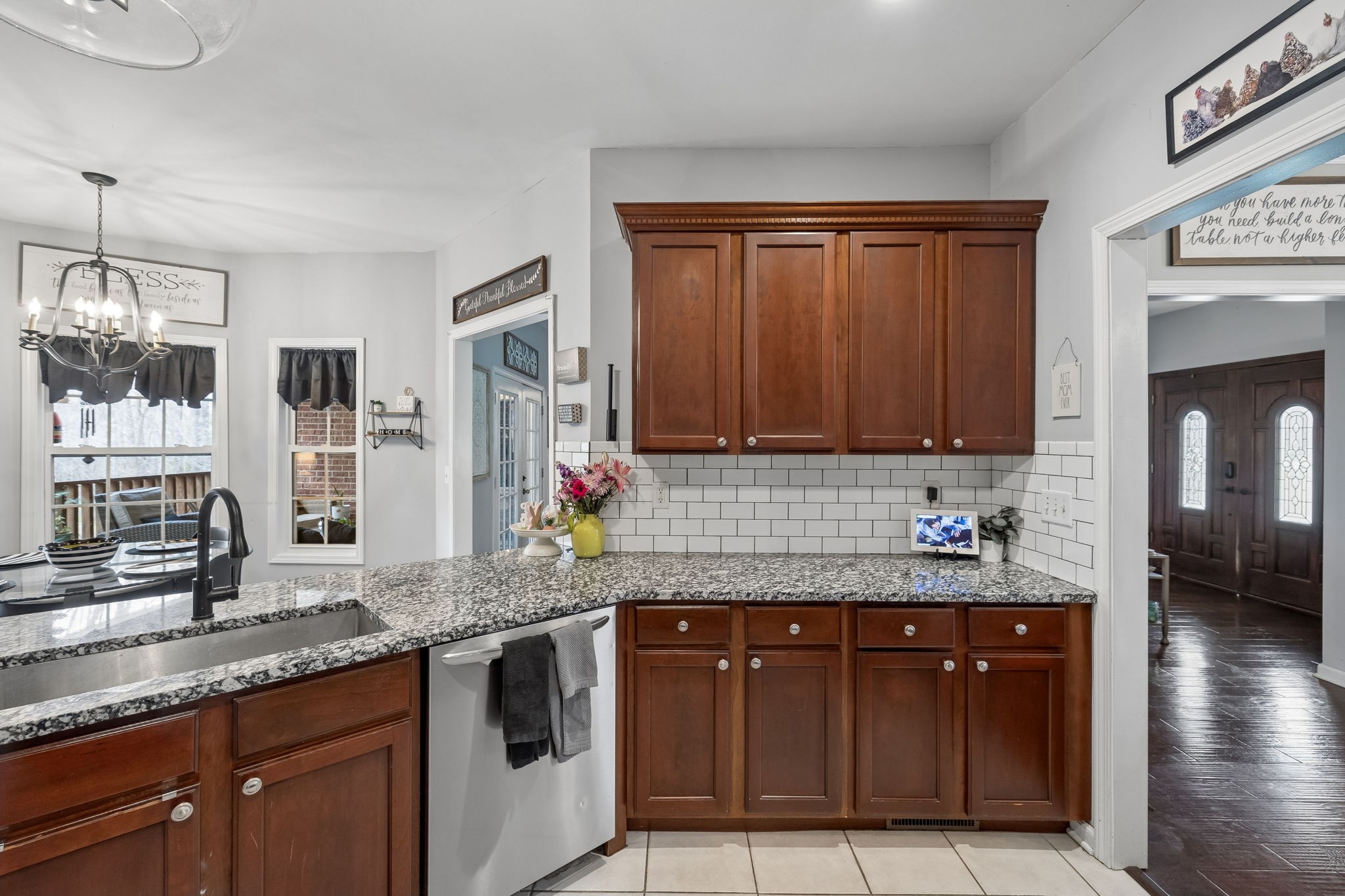 119 Christi Place Pleasant View, TN 37146 - Photo 15 of 62 a kitchen with granite countertop a sink stainless steel appliances wooden floor and cabinets