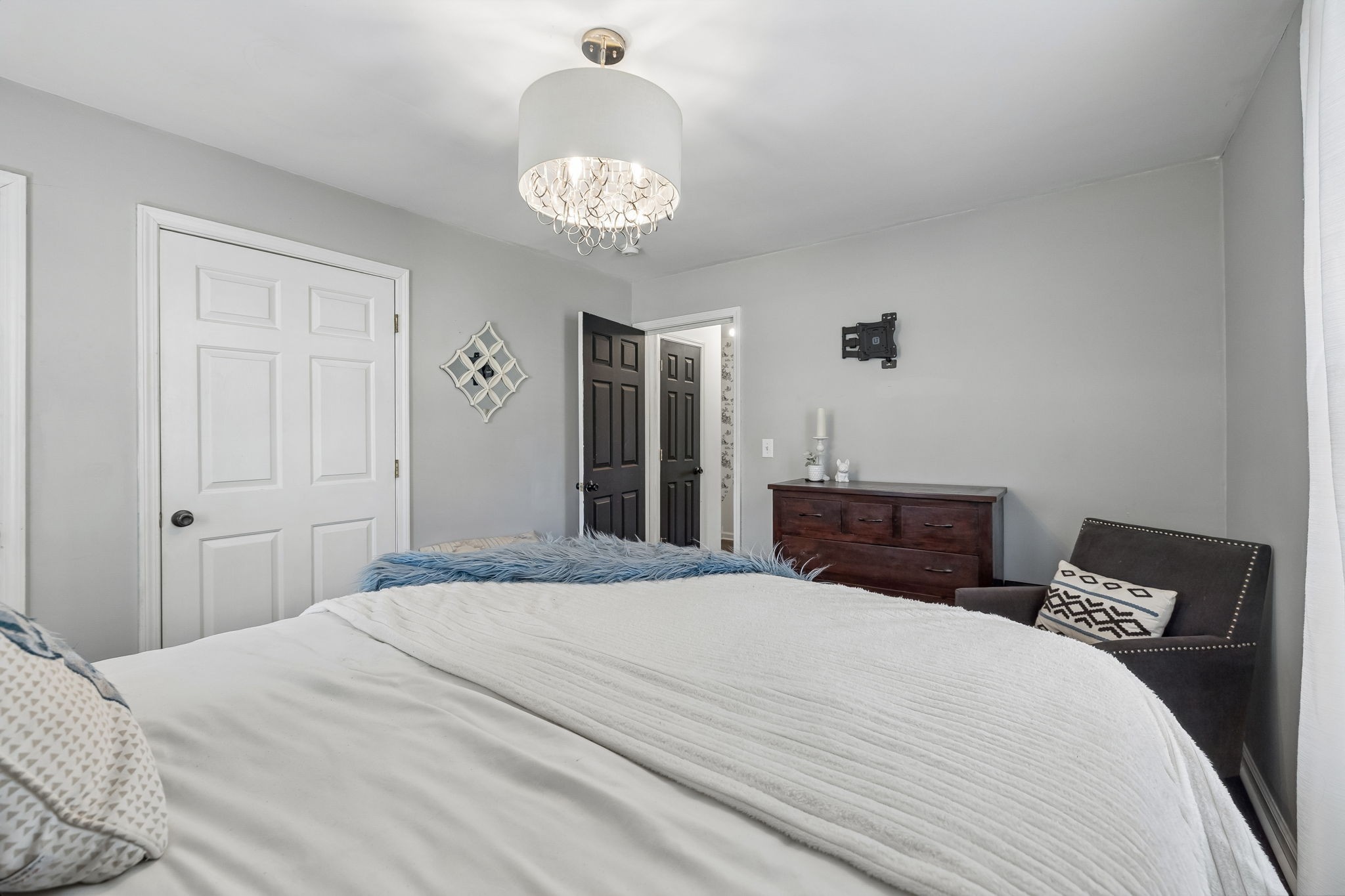119 Christi Place Pleasant View, TN 37146 - Photo 35 of 62 a bedroom with a bed and a chandelier
