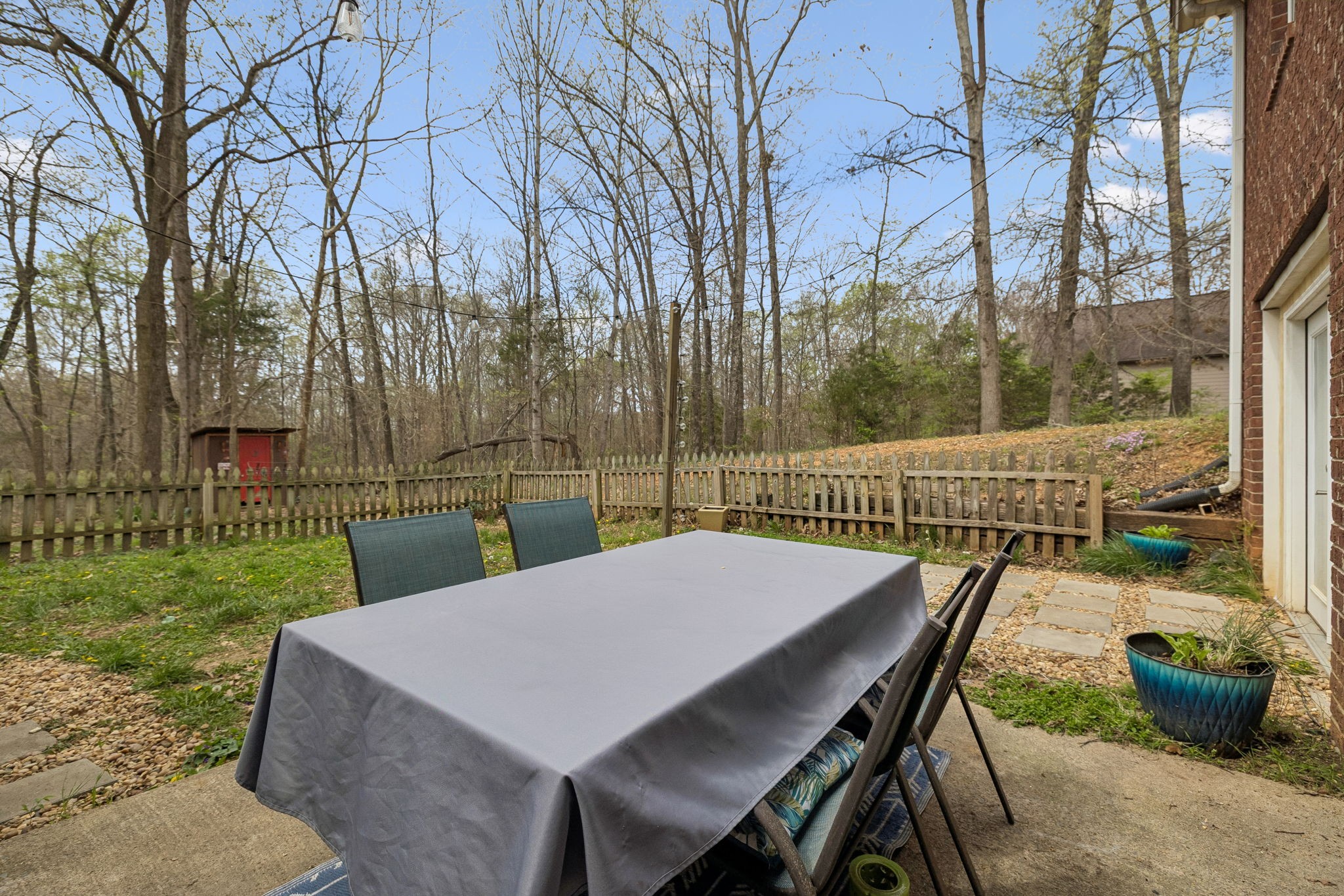 119 Christi Place Pleasant View, TN 37146 - Photo 40 of 62 a view of a patio with table and chairs next to a yard