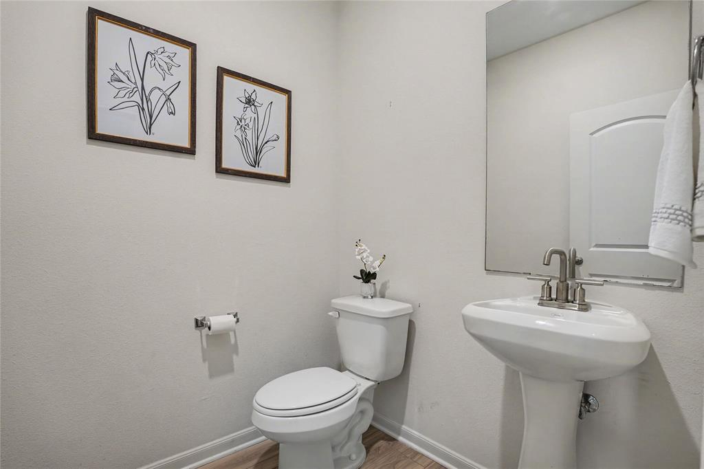 125 Sammy Venus, TX 76084 - Photo 24 of 39 Pedestal sink with brushed nickel faucet, neutral wall color, and wood-finish flooring
