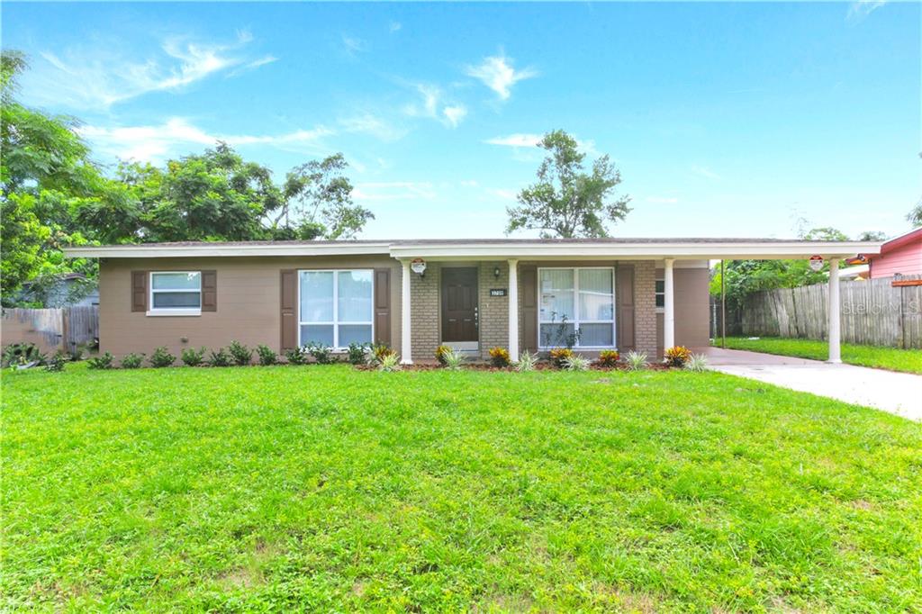 3709 Wade Road Orlando, FL 32808 - Photo 1 of 1 front view of a house with a garden