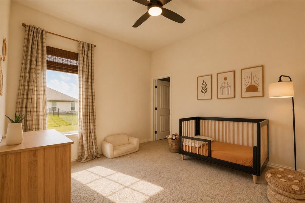 1530 County Road 200 Valley View, TX 76272 - Photo 29 of 34 Carpeted room featuring a single window with blinds and plaid drapes, a ceiling fan, and a light-toned interior door