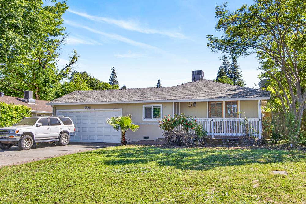 8780 Elm Avenue Orangevale, CA 95662 - Photo 1 of 23 a front view of a house with garden