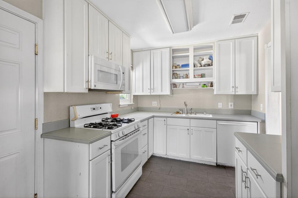 8780 Elm Avenue Orangevale, CA 95662 - Photo 7 of 23 a kitchen with stainless steel appliances granite countertop a sink stove and cabinets
