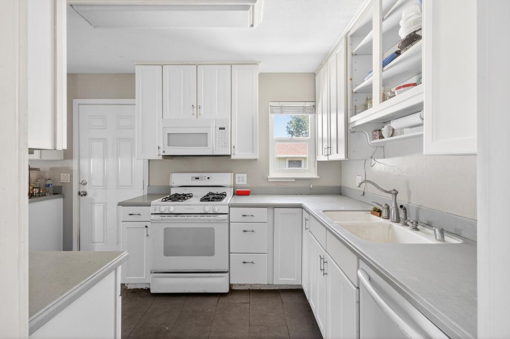 8780 Elm Avenue Orangevale, CA 95662 - Photo 8 of 23 a kitchen with white cabinets and white appliances