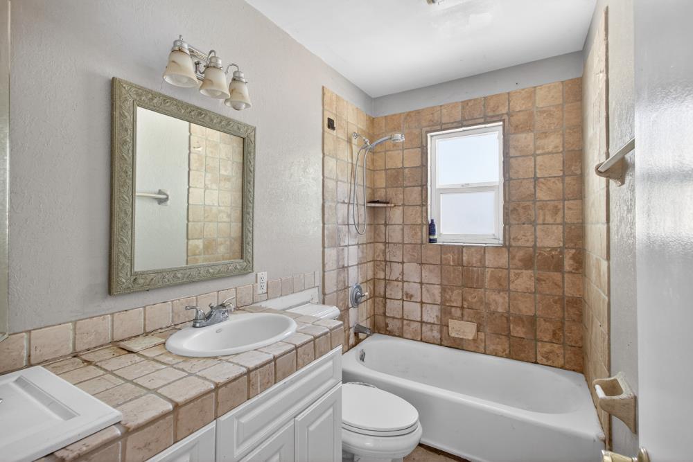 8780 Elm Avenue Orangevale, CA 95662 - Photo 10 of 23 a bathroom with a granite countertop sink toilet and shower