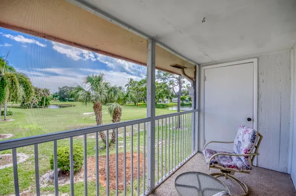 a view of a porch with furniture and yard