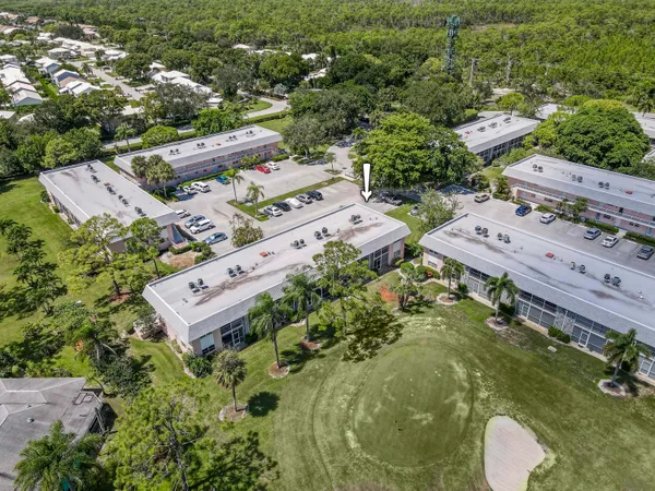 an aerial view of a house with a yard basket ball court and outdoor seating