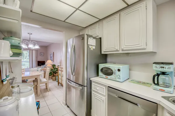 a kitchen with stainless steel appliances granite countertop a refrigerator sink and cabinets