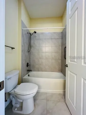 a bathroom with a toilet and a bath tub