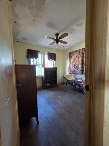 a room with stairs and a chandelier fan
