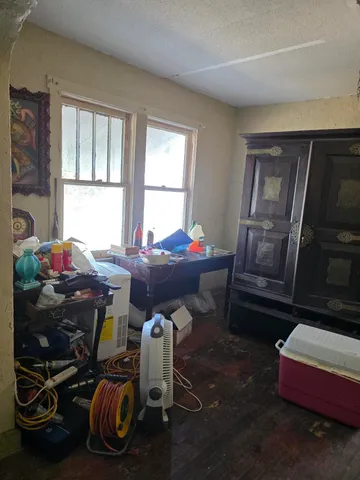 a living room with furniture and a dining table