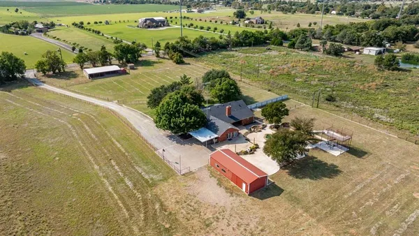 an aerial view of a garden with swimming pool