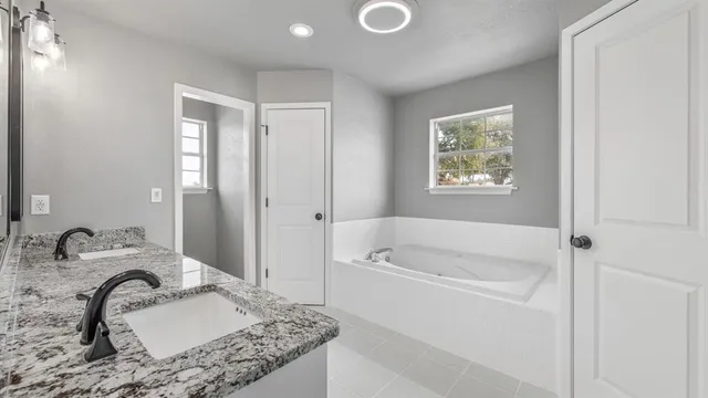 a bathroom with double sink and a mirror