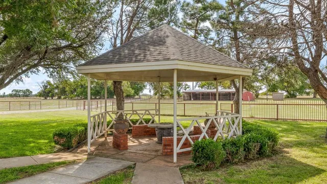a view of a house with a large space and a car parked side of it