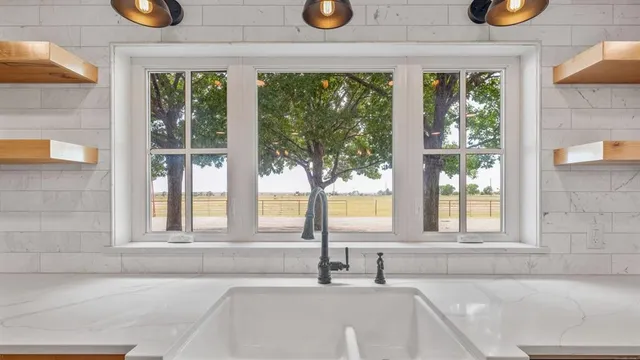 a bathroom with a sink and a large window