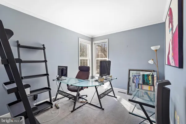 a view of a livingroom with furniture and a workspace