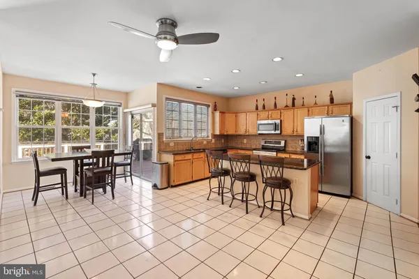 a kitchen with stainless steel appliances a sink counter space and a window