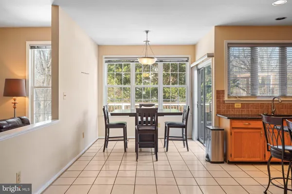 a dining room with furniture a chandelier and window