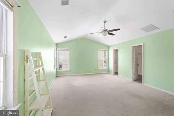 a bathroom with a toilet sink vanity and mirror