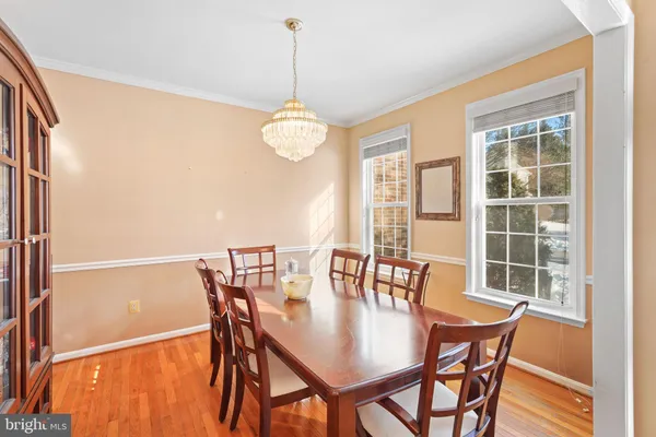 a view of a dining room with furniture wooden floor and chandelier