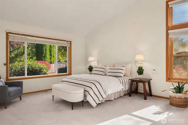 a bedroom with furniture and a large window