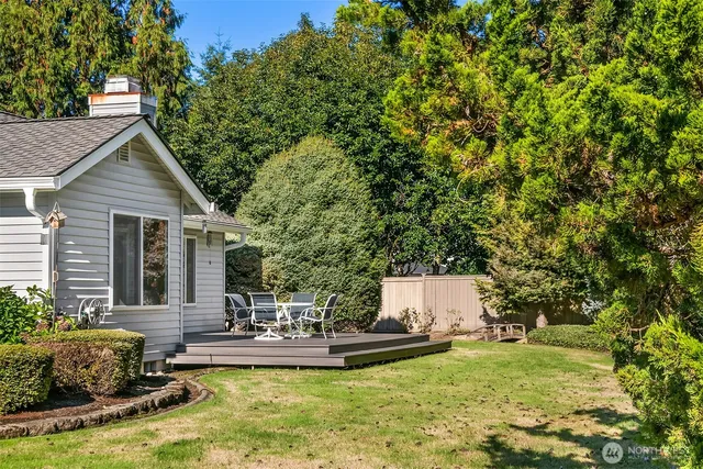 a view of a house with swimming pool and sitting area