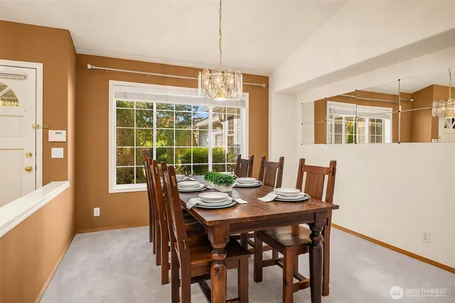 a view of a dining room with furniture large windows and wooden floor