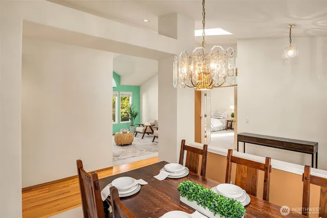 a view of a dining room with furniture and chandelier