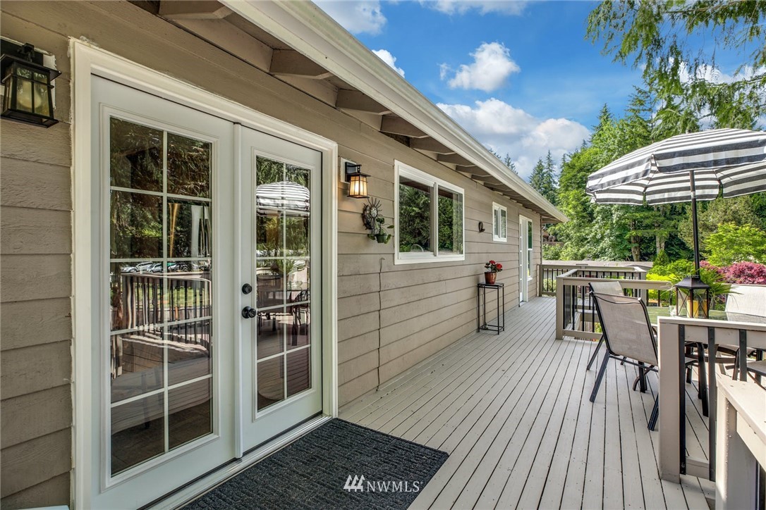 21910 1st Place West Bothell, WA 98021 - Photo 22 of 33 a view of a patio with table and chairs with wooden floor and fence