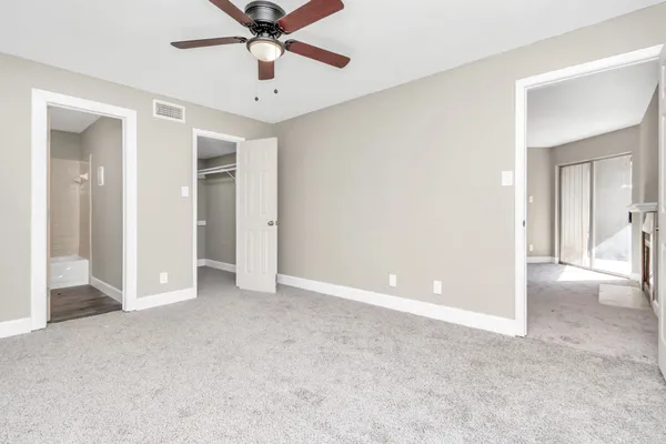a view of empty room with ceiling fan