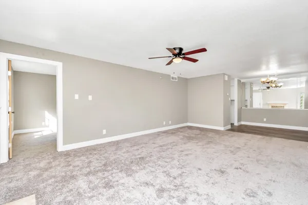 a view of room with a ceiling fan and window