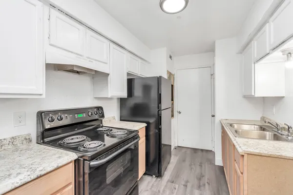 a kitchen with a stove and a refrigerator