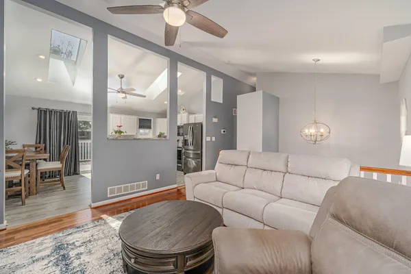 a living room with furniture and a wooden floor