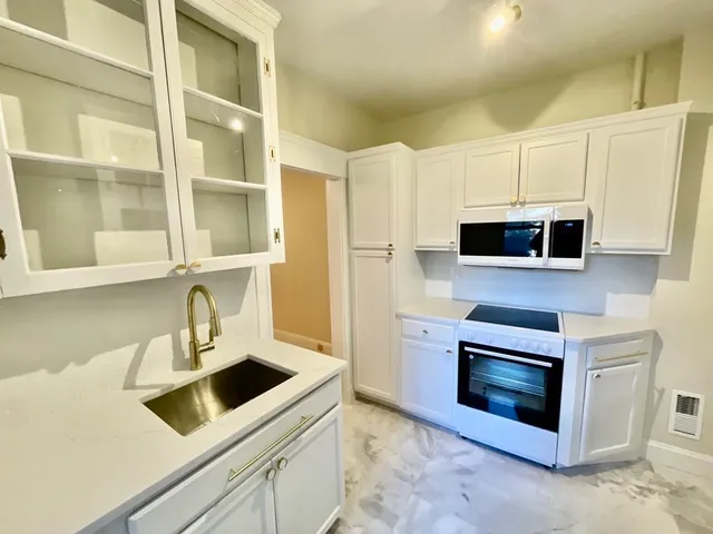 a kitchen with a stove and a microwave