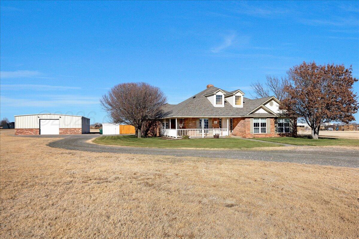a front view of a house with a big yard