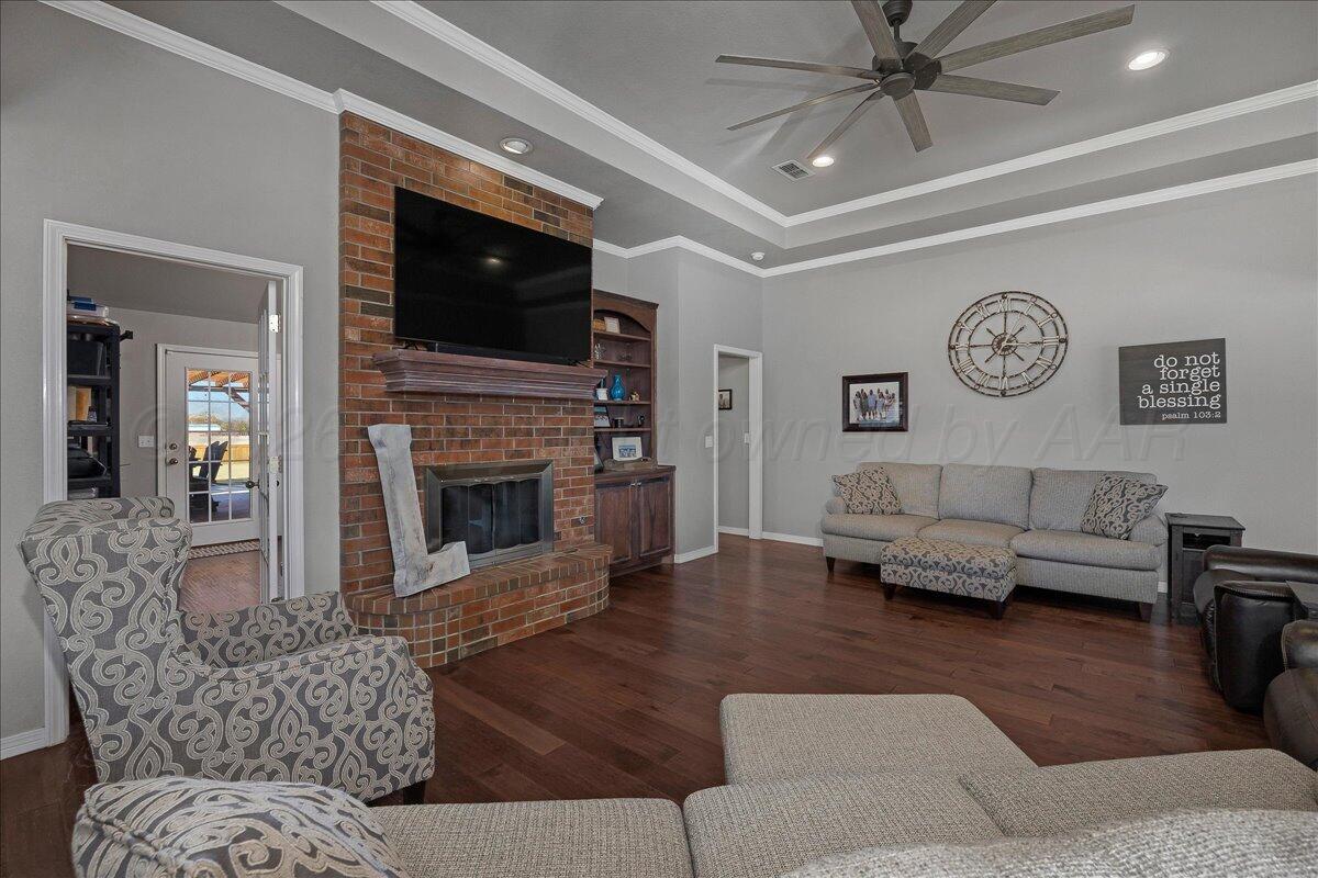 8910 Dove Road Canyon, TX 79015 - Photo 12 of 47 a living room with furniture a flat screen tv and a fireplace