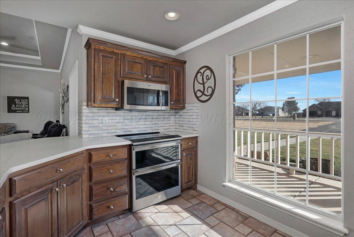 8910 Dove Road Canyon, TX 79015 - Photo 17 of 47 a kitchen with stainless steel appliances a stove and cabinets