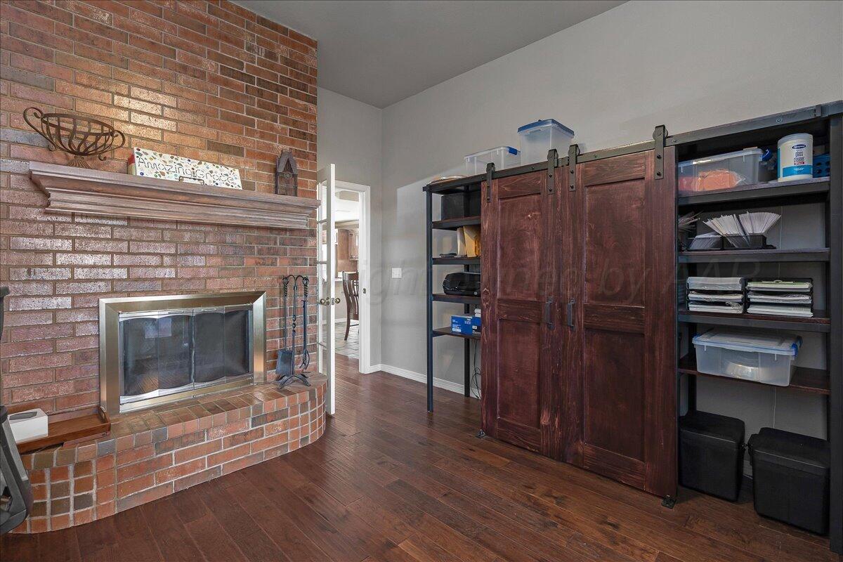 8910 Dove Road Canyon, TX 79015 - Photo 20 of 47 a living room with wooden floors and a fireplace